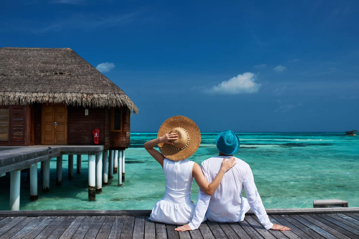 Couple on a beach jetty at Maldives